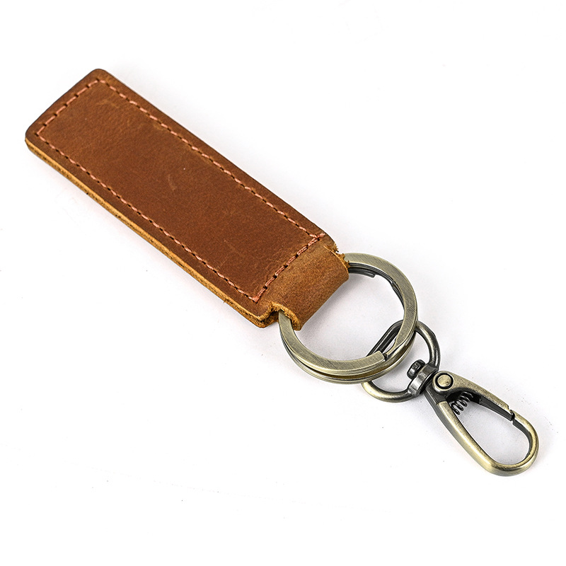 Porte clés en cuir de vachette marron 80x27mm et 2 anneaux bronze 30mm, unité