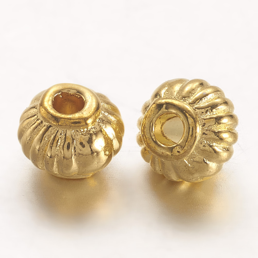 Perle séparateur en alliage doré, style tibetain, toupie, environ 5x4mm de long, trou 1,5mm, l'unité